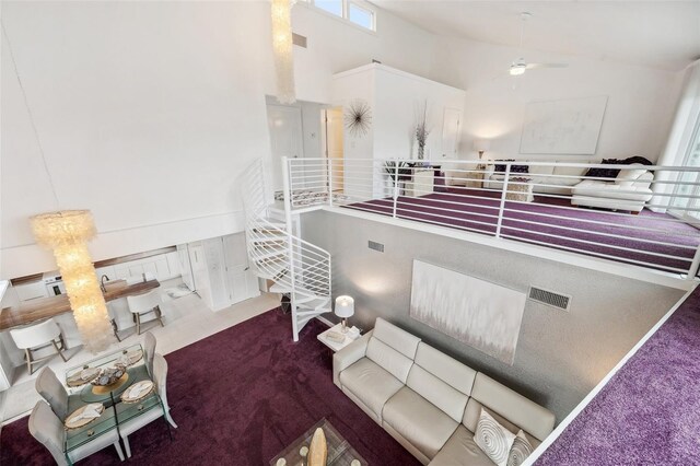 17404 1st St E, Redington Shores, FL 33708 - living room featuring a high ceiling, carpet floors, and a ceiling fan