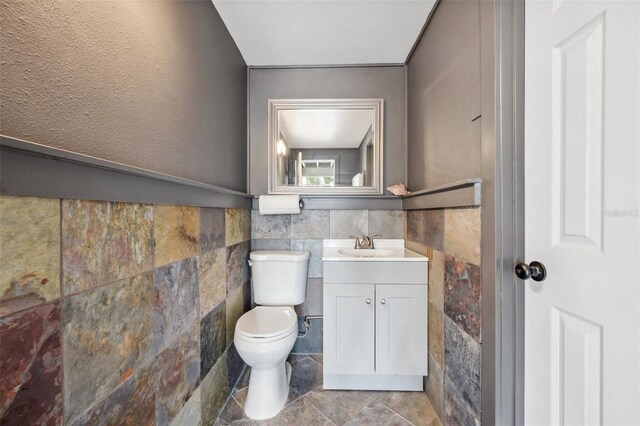 17404 1st St E, Redington Shores, FL 33708 - half bath with tile walls, toilet, and vanity