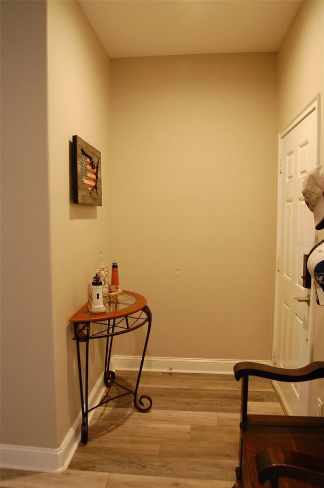 interior space featuring light wood-style flooring and baseboards