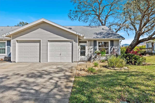 ranch-style home featuring concrete driveway, a front lawn, an attached garage, and a shingled roof