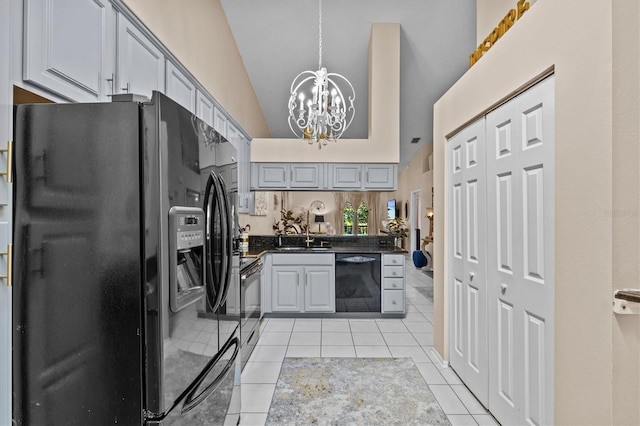 kitchen featuring gray cabinetry, an inviting chandelier, light tile patterned flooring, vaulted ceiling, and black appliances