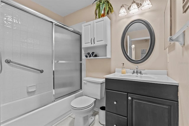 full bathroom with shower / bath combination with glass door, vanity, toilet, and tile patterned floors