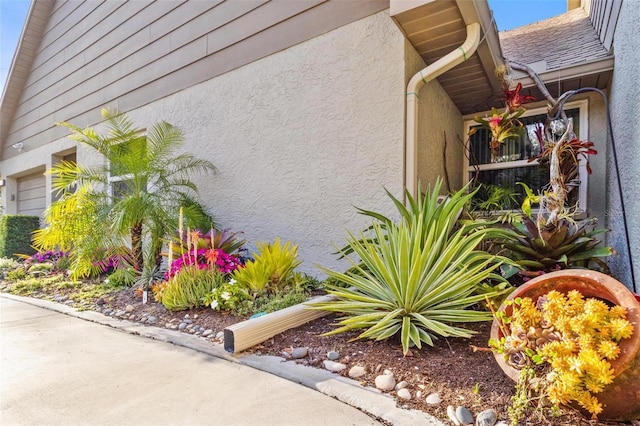 view of side of home with stucco siding