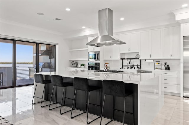 kitchen featuring open shelves, ornamental molding, white cabinets, built in appliances, and island range hood