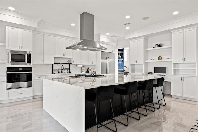 kitchen featuring a large island, marble finish floor, open shelves, built in appliances, and extractor fan