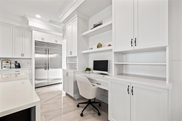 office area with recessed lighting, marble finish floor, and built in desk