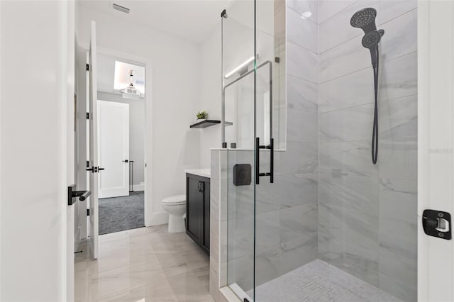 bathroom with visible vents, toilet, a stall shower, baseboards, and vanity