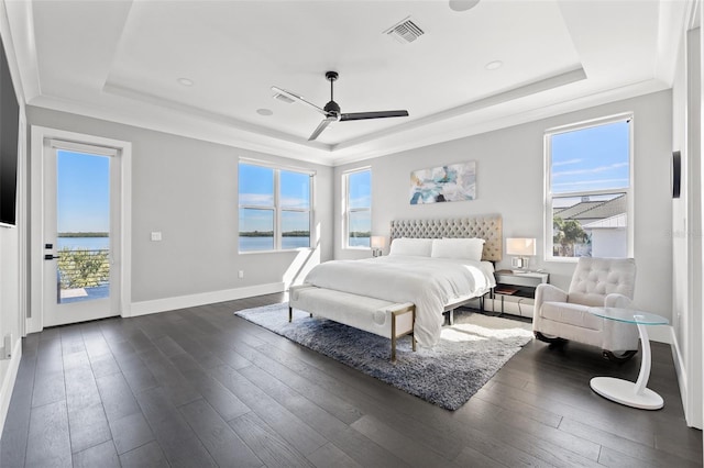 bedroom with access to outside, visible vents, a raised ceiling, and dark wood-style flooring