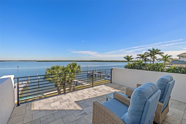 view of patio with a balcony and a water view