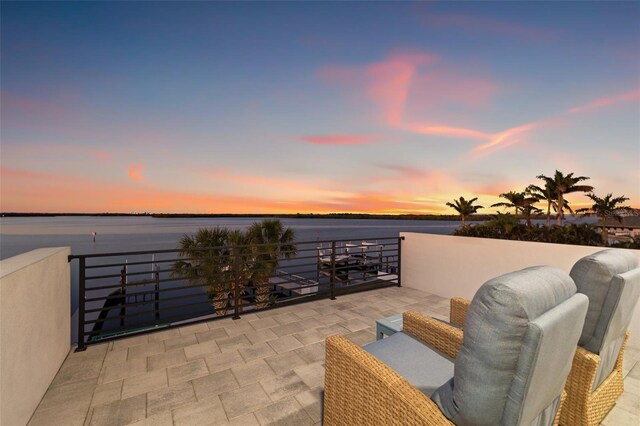 view of patio / terrace with a balcony and a water view