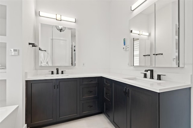 bathroom with a sink, a tub, double vanity, and tile patterned flooring