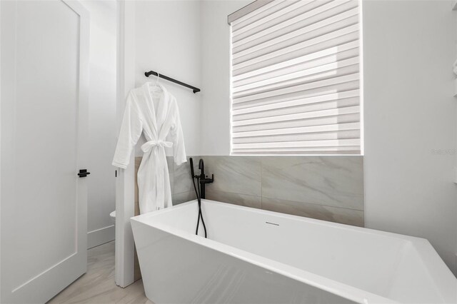 bathroom with plenty of natural light and a soaking tub