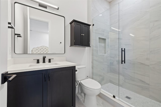 full bath with vanity, toilet, and a shower stall