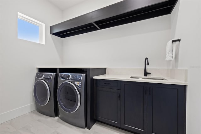 laundry area with marble finish floor, a sink, cabinet space, baseboards, and washing machine and clothes dryer