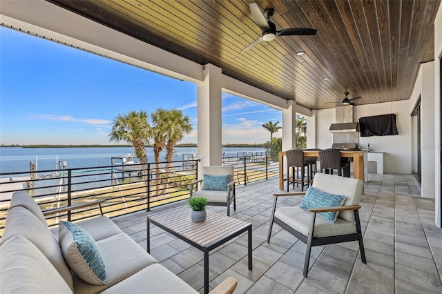 view of patio featuring an outdoor living space, outdoor dining area, a water view, and ceiling fan