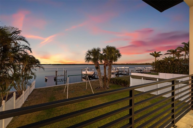 exterior space with fence and a water view