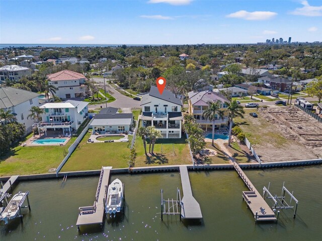 drone / aerial view with a water view and a residential view