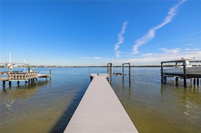 view of dock with boat lift and a water view