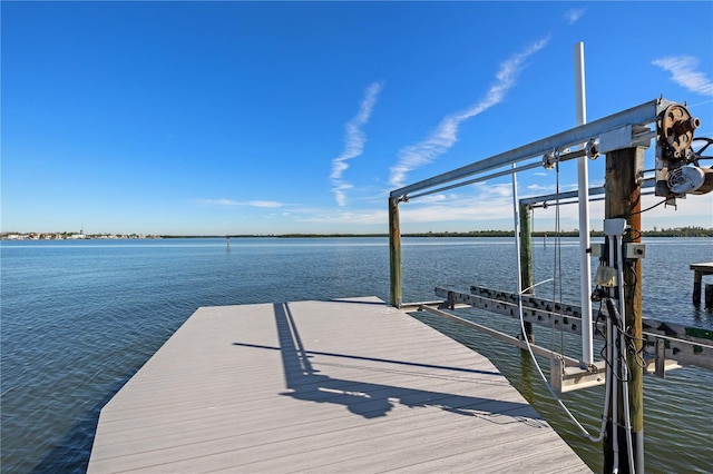 dock area with a water view and boat lift