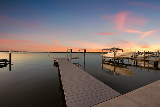 dock area with a water view and boat lift