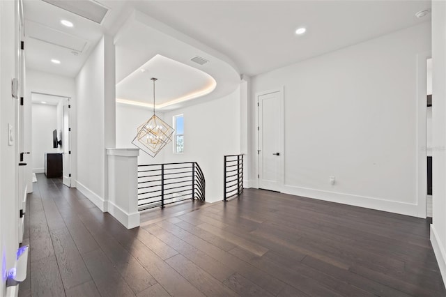 hallway with an upstairs landing, attic access, dark wood finished floors, baseboards, and recessed lighting