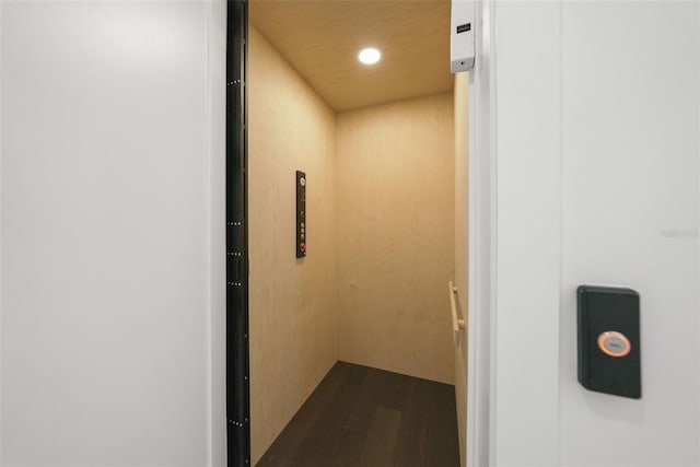 details featuring elevator, wood finished floors, and recessed lighting