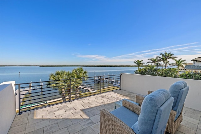 view of patio / terrace featuring a balcony and a water view