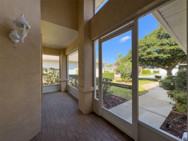 unfurnished sunroom featuring a wealth of natural light