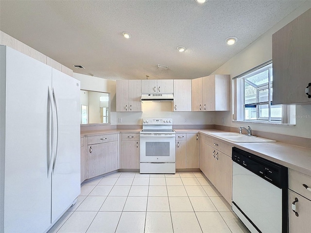 kitchen with white appliances, light countertops, a sink, and under cabinet range hood