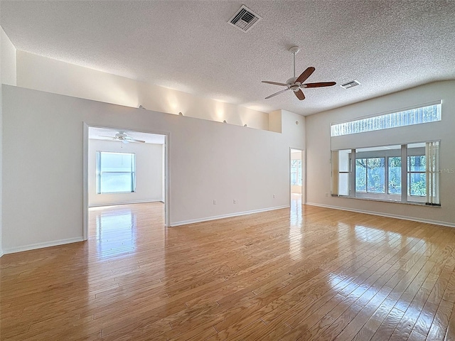 spare room with a ceiling fan, visible vents, and light wood-style flooring