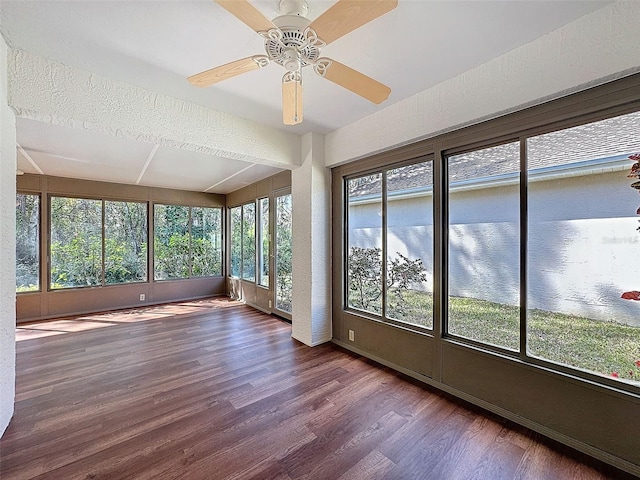 unfurnished sunroom with a ceiling fan