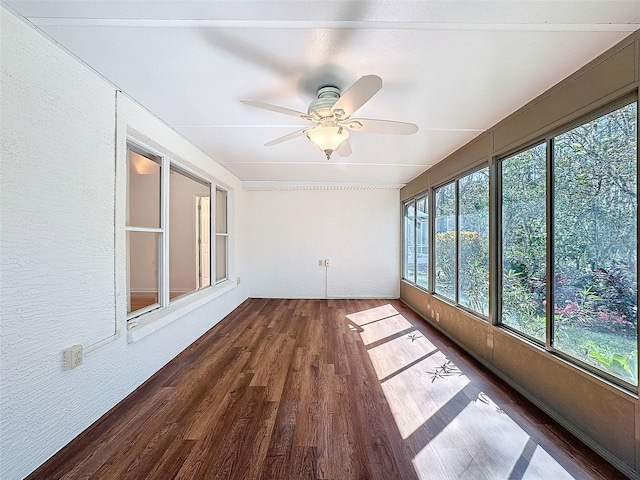 unfurnished sunroom with plenty of natural light and a ceiling fan