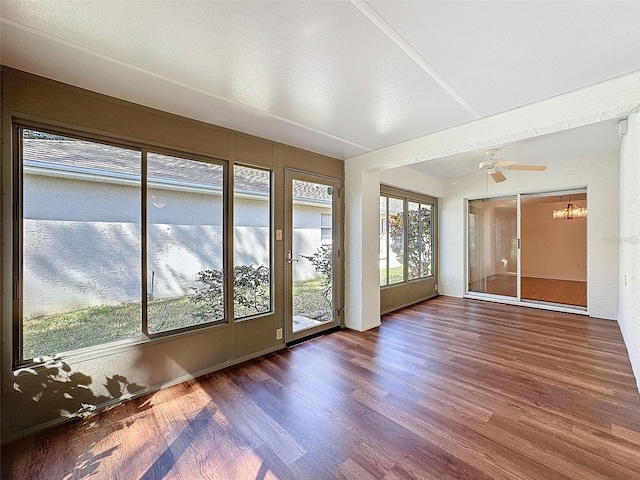 unfurnished sunroom with ceiling fan