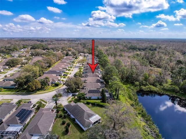 bird's eye view with a wooded view