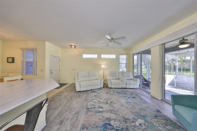 living area featuring wood finished floors and a ceiling fan