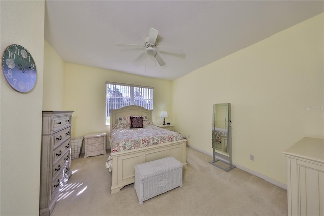 bedroom with light carpet, ceiling fan, and baseboards