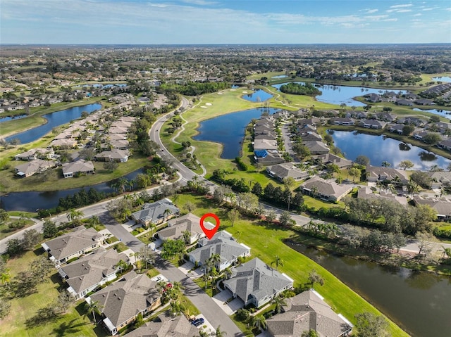 drone / aerial view with a water view and a residential view