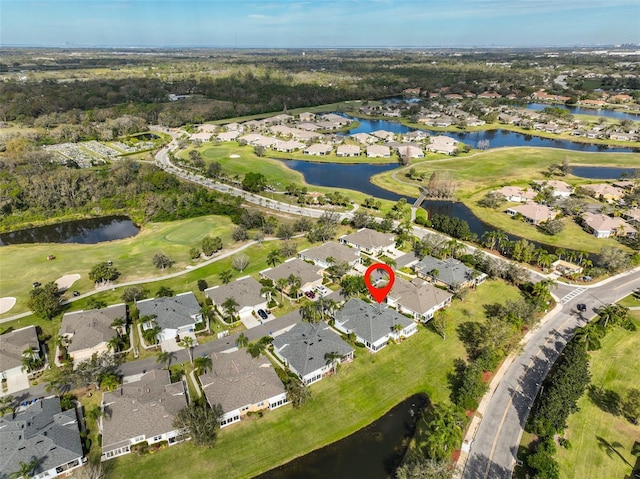 drone / aerial view with a water view, a residential view, and golf course view