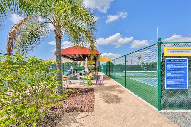 view of tennis court featuring fence