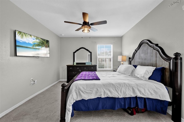 carpeted bedroom with ceiling fan and baseboards