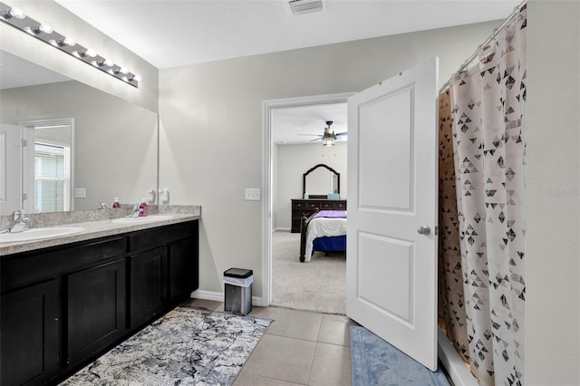 bathroom with visible vents, a shower with shower curtain, a ceiling fan, vanity, and tile patterned floors