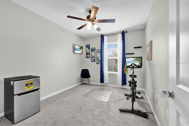 workout room with carpet floors, baseboards, and a ceiling fan