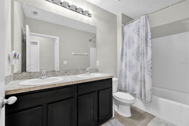 bathroom with shower / bath combination with curtain, tile patterned flooring, a sink, and double vanity