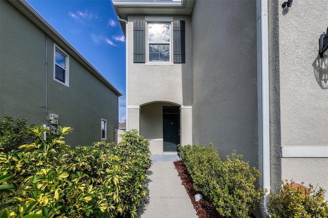 doorway to property with stucco siding