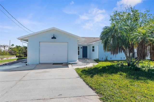 ranch-style house with a garage, concrete driveway, and stucco siding