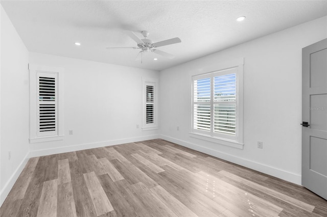 empty room with light wood finished floors and baseboards