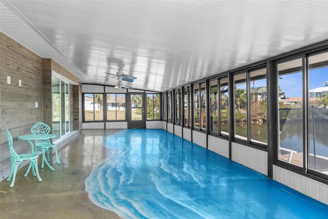 unfurnished sunroom with ceiling fan and a wealth of natural light