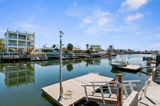 view of dock with a water view and a residential view