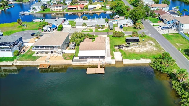 birds eye view of property with a water view and a residential view