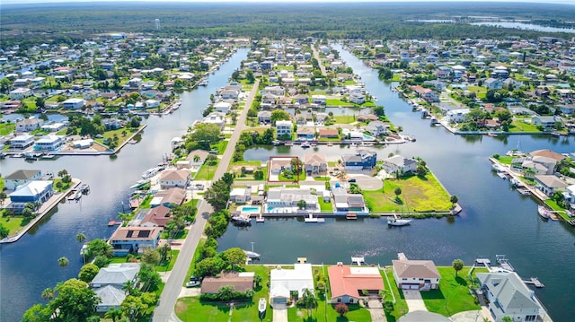 drone / aerial view featuring a water view and a residential view